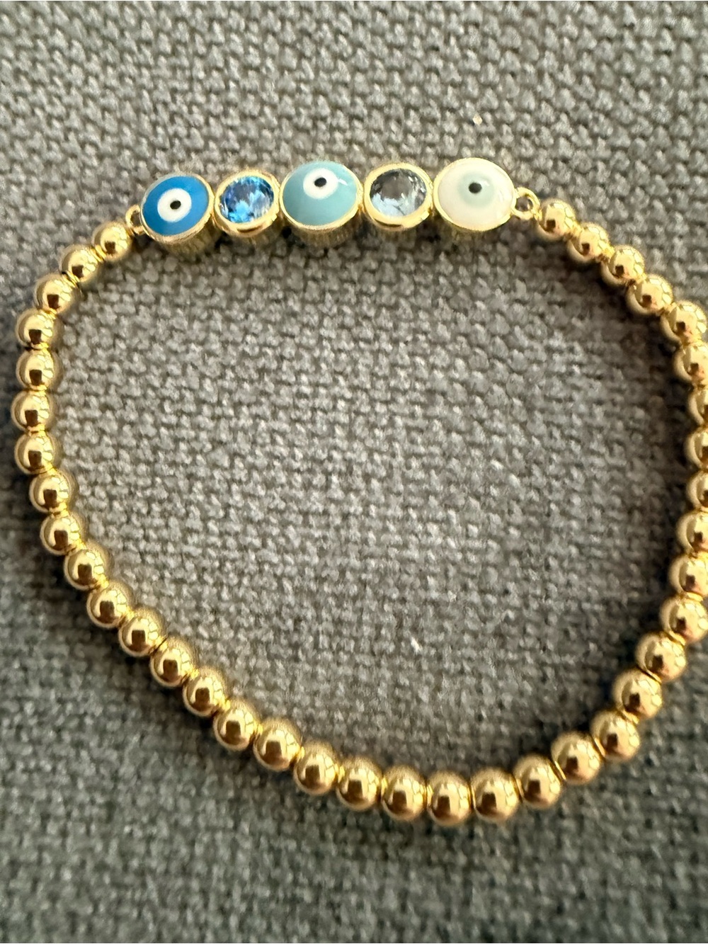 Gold Beaded Stretch Bracelet with Blue Evil Eye Accents